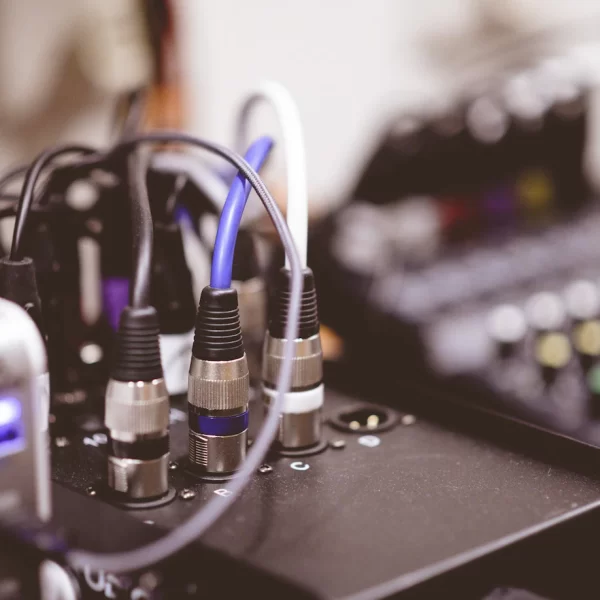 closeup-shot-plugged-electronic-cables-blurred-background_181624-9973